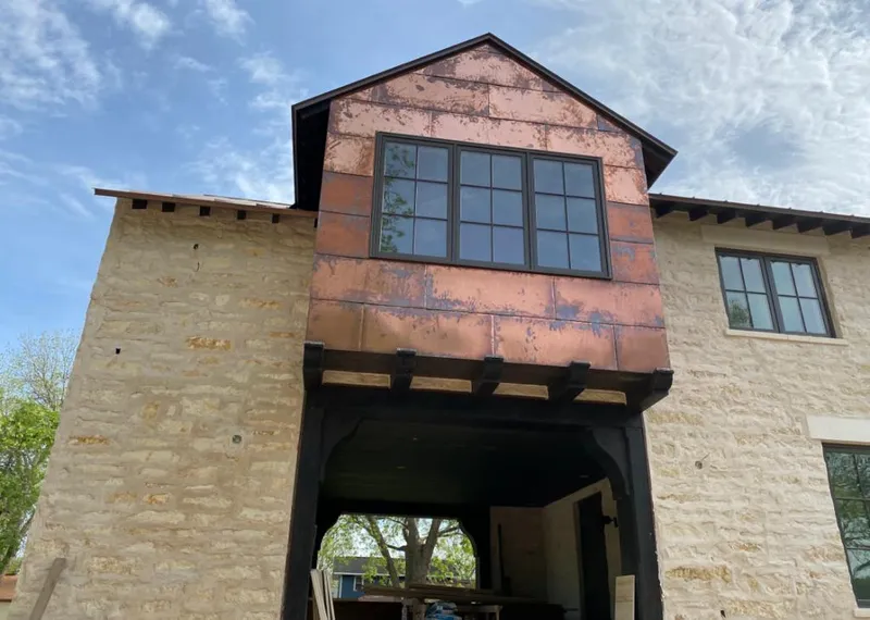Copper metal panel facade on a stone building for Roof Repair in Soquel